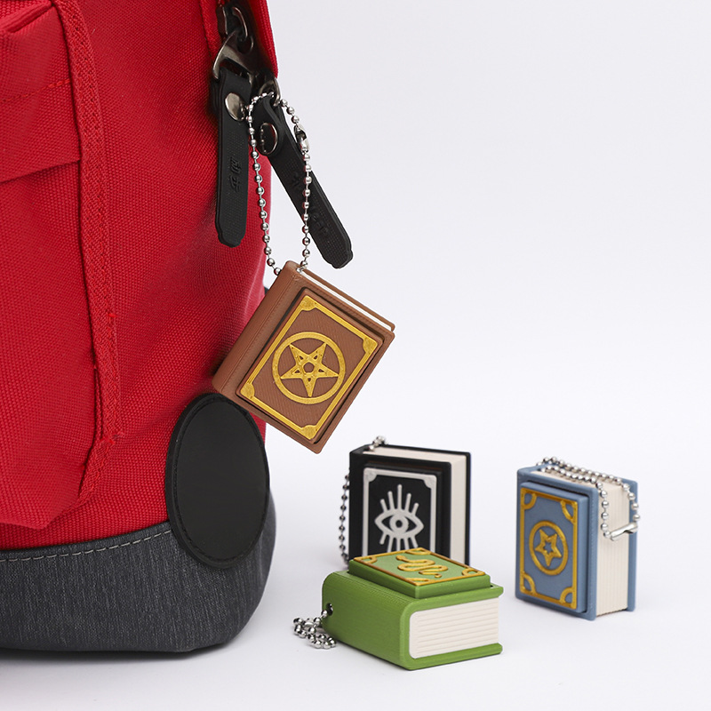 3D-printed magic book stress-relief keychain charm